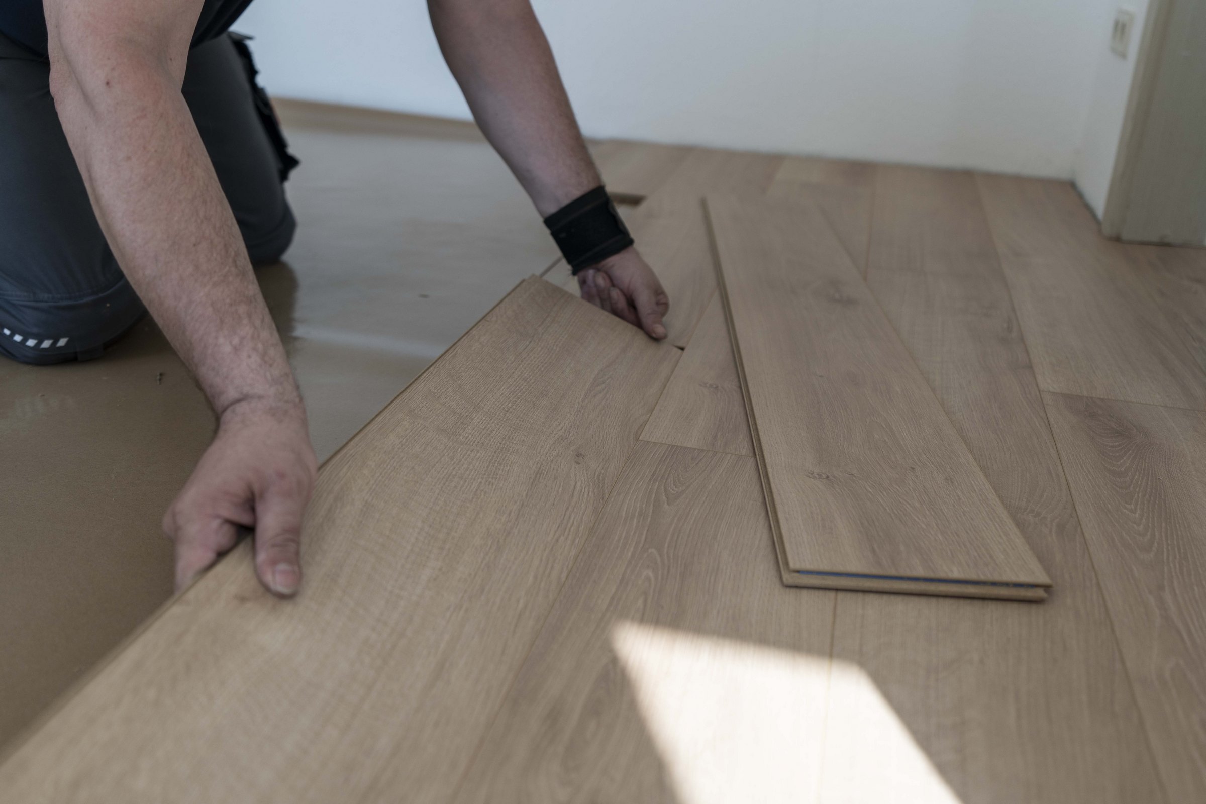 Laminate flooring planks being fitted during installation